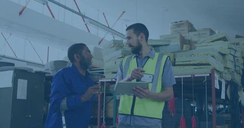 Warehouse worker consulting with supervisor holding tablet