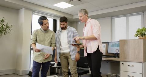 Diverse Team Collaborating on Data and Planning Office Strategy