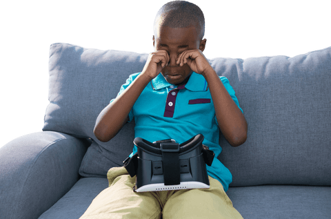 little african american boy rubbing against vr simulator on couch in blue shirt - Download Free Stock Videos Pikwizard.com