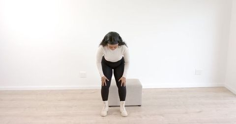 Woman Embracing Relaxation in Bright Minimalist Room