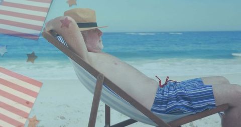 Older Man Relaxing in Beach Chair by Seaside in Striped Shorts