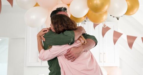 Couple embracing at engagement celebration at home
