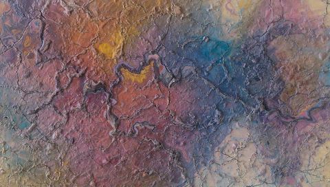 Cracked Colorful Textured Surface Close-Up Revealing Iridescent Raised Ridges and Grooves