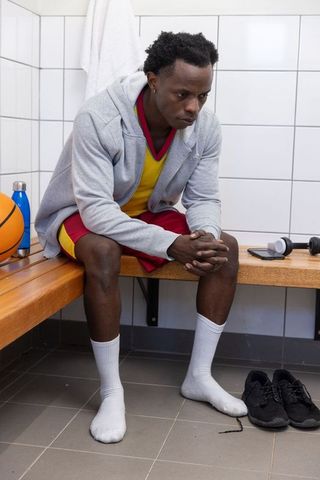 Basketball Player Relaxing in Locker Room Post-Workout