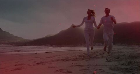 Mature Couple Enjoying a Romantic Beach Run at Sunrise