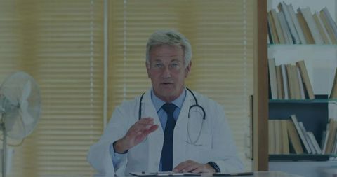 Senior Doctor Engaging in Patient Consultation in Modern Office