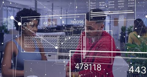 Coworkers collaborating over laptop with digital analytics overlays and data visualization