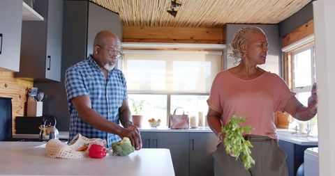 Senior Couple Enjoying Chat in Bright Modern Kitchen