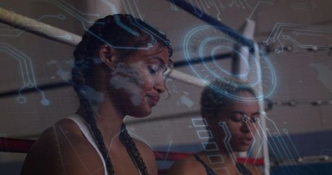 Female boxers with futuristic digital overlay in ring