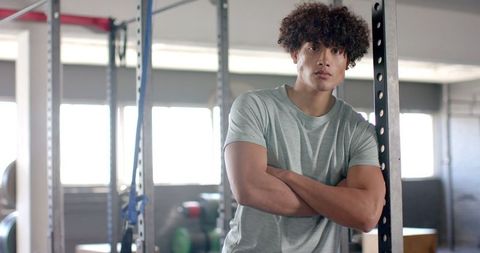 Confident Young Man Relaxing in Modern Gym Environment