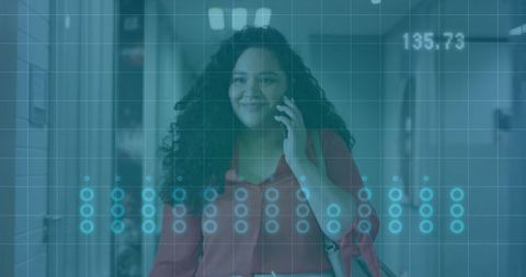 Businesswoman Engages on Smartphone in Modern Office Corridor