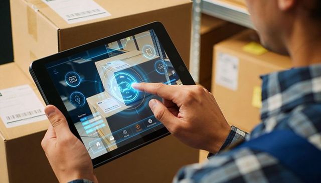 Warehouse worker tapping tablet with augmented reality inventory scan and order dashboard