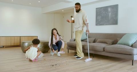 Family engaging in fun cleaning activity at home