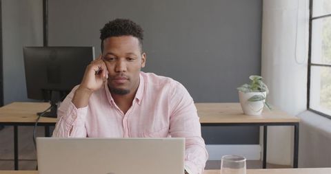 Businessman Engaged at Laptop in Modern Office Environment