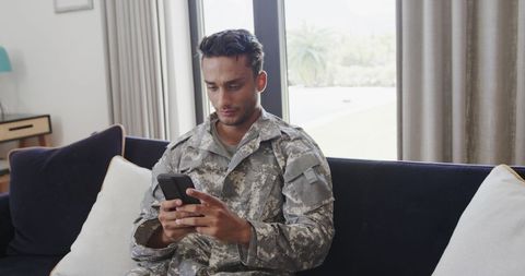 Army Soldier Relaxing at Home Checking Smartphone