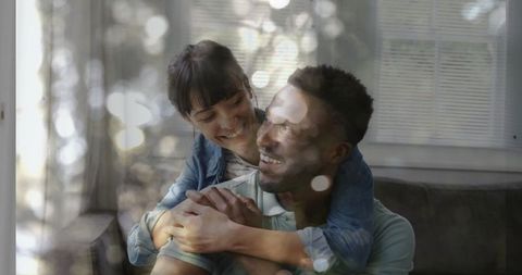 Couple Embracing in Cozy Living Room with Soft Warm Lighting