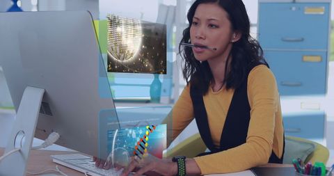 Asian Businesswoman Engaging with Digital Interfaces on Computer