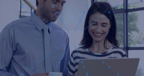 Business colleagues collaborating over laptop with data visualization overlay