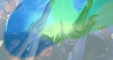 Friends Dancing Under Colorful Lights at a Concert