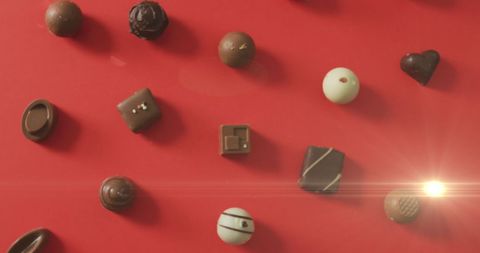 Variety of Delicate Chocolate Pralines on Red Background