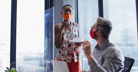 Masked Office Workers Collaborating Safely Mid-Pandemic