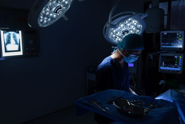 Male surgeon performing operation in operation theater at hospital