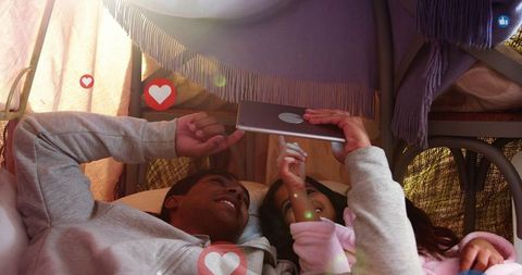 Father and Daughter Bonding with Tablet in Cozy Tent