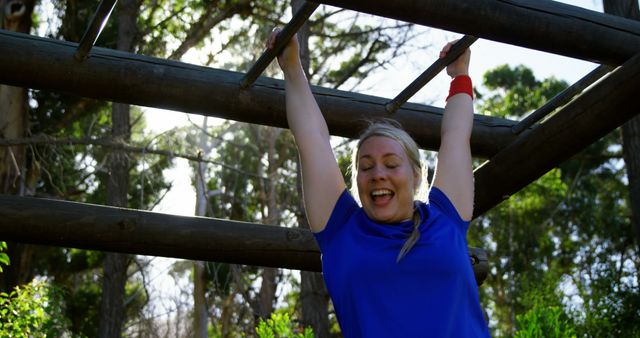 Woman Exercising on Monkey Bars in Sunlit Park - Download Free Stock Images Pikwizard.com