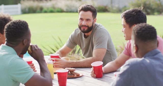 Friends Enjoying Outdoor Picnic with Drinks and Food on Table - Download Free Stock Images Pikwizard.com