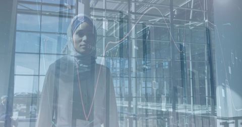 Businesswoman in hijab analyzing financial trends in modern office