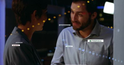 Colleagues Analyzing Digital Data in High-Tech Office Environment