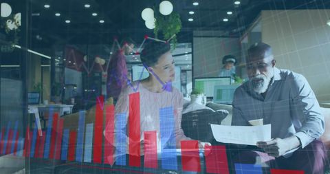 Diverse Colleagues Analyzing Financial Charts in Modern Office