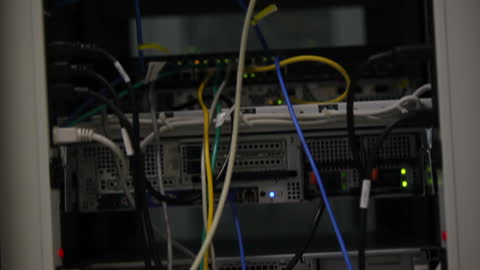 Close-Up View of Server Rack with Cables and LED Lights