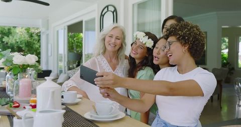 Smiling Women Taking Selfie at Home Wedding Celebration