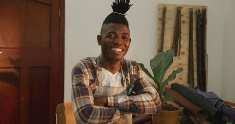 Craftsman in Plaid Shirt Smiling in Leather Workshop