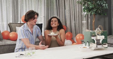 Happy Couple Celebrating Birthday with Candle on Cupcake