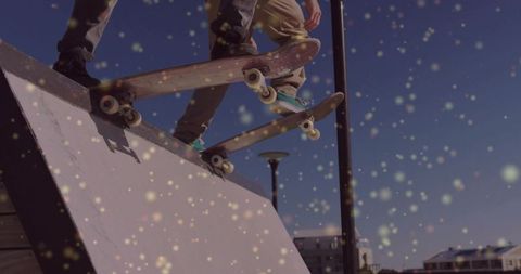 Skateboarders launching off ramp with sparkling bokeh lights urban action duo midair tricks skatepar