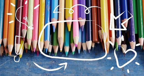 Colorful Pencils with Creative Chalk Doodles on Blue Wood Background