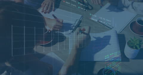 Business Team Analyzing Financial Data Overlaid with Graphs