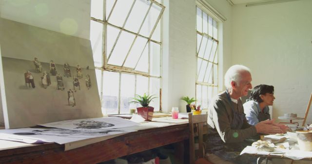 Two Artists Working in Sunlit Studio with Art Supplies - Download Free Stock Images Pikwizard.com