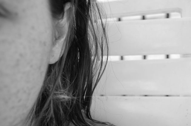 Captured at close range, focusing on part of the woman's face. Perfect for use in projects related to introspection, emotions, photography, and portrait art. Applicable for blog posts, mental health websites, artistic decorations, and mood exploration themes.