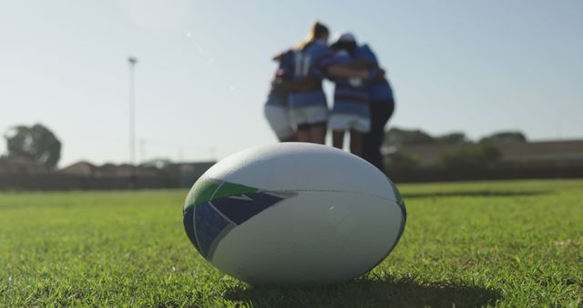 Rugby Players Huddling on Field Near Ball - Download Free Stock Images Pikwizard.com