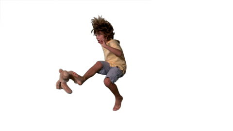 Cheerful Boy Playfully Jumping with Stuffed Toy