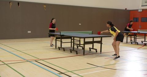 Dynamic table tennis competitors in sports hall