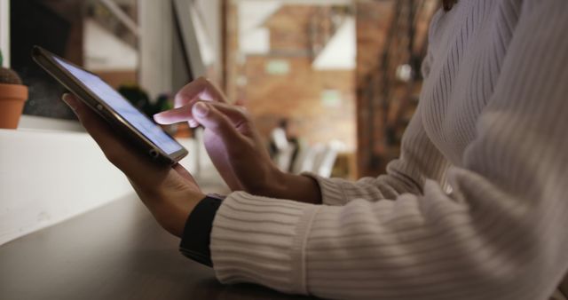 Person Using Tablet in Cozy Café Environment - Download Free Stock Images Pikwizard.com