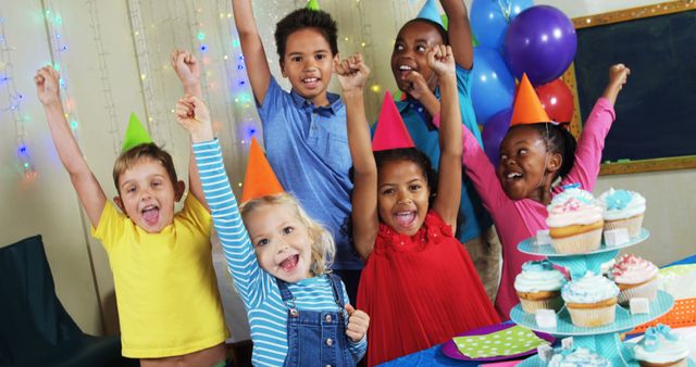 Joyful Kids Celebrating Birthday with Party Hats and Cupcakes - Download Free Stock Images Pikwizard.com