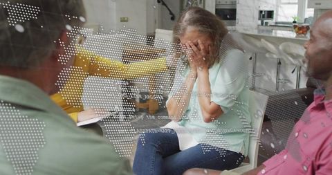 Support group comforting woman covering face in emotional home counseling resilience talk