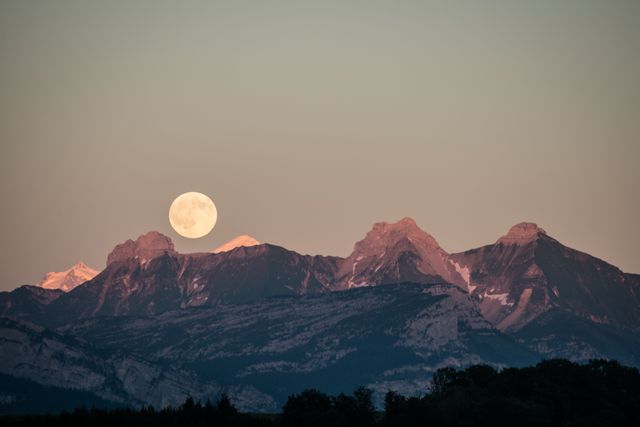 Full Moon Rising Over Rugged Mountain Range at Twilight - Download Free Stock Photos Pikwizard.com