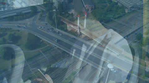 Double Exposure With Man Using Smartphone and Urban Roads