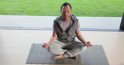 Man Practicing Meditation and Mindfulness at Home Entrance